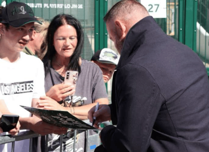 Damian Bowyer and mum Helen meeting Wayne Rooney who signed his birthday card and posed for a photo.