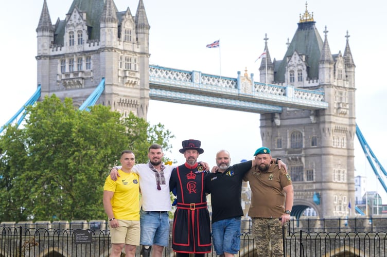 Charity rowers Sam, Igor, Andy, Lee and Ivan in London where Andy is a Tower of London warder.