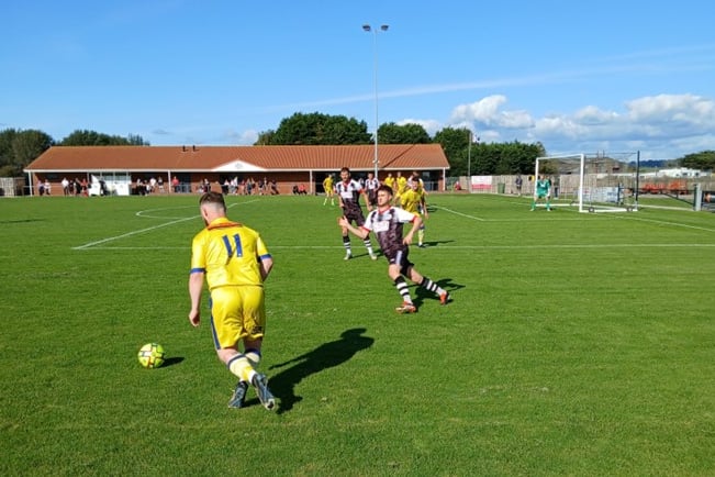 Billy Tucker delivering a cross for Okehampton Argyle