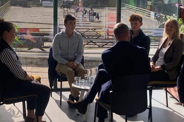 The Prince chatted intently with students and staff about the Future Farm programme in Sam's cafe, while an equine demonstration takes place in the background. (Picture: Sarah Martin).