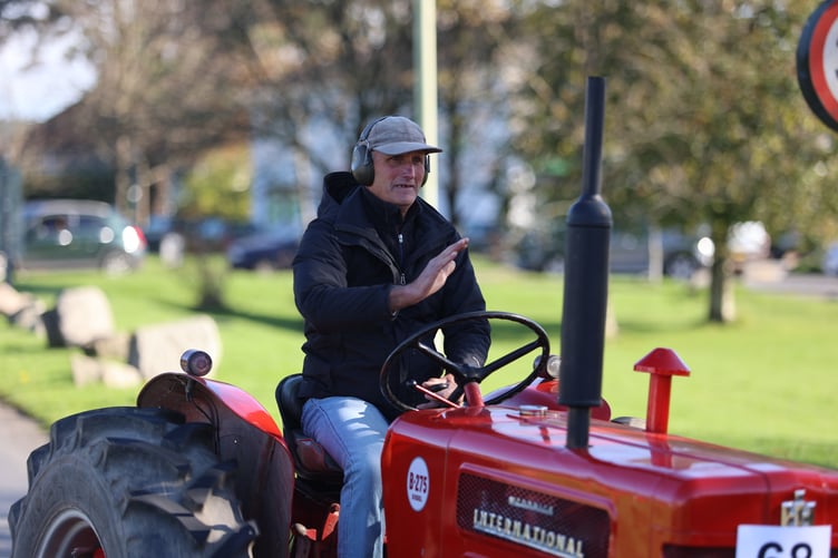 A lovingly-polished red tractor draws admiration on the roads of West Devon as farm vehicles provide a spectacle at a rally at Yelverton former airfield.
