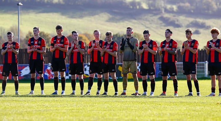 Tavistock AFC players pause for a minutes silence