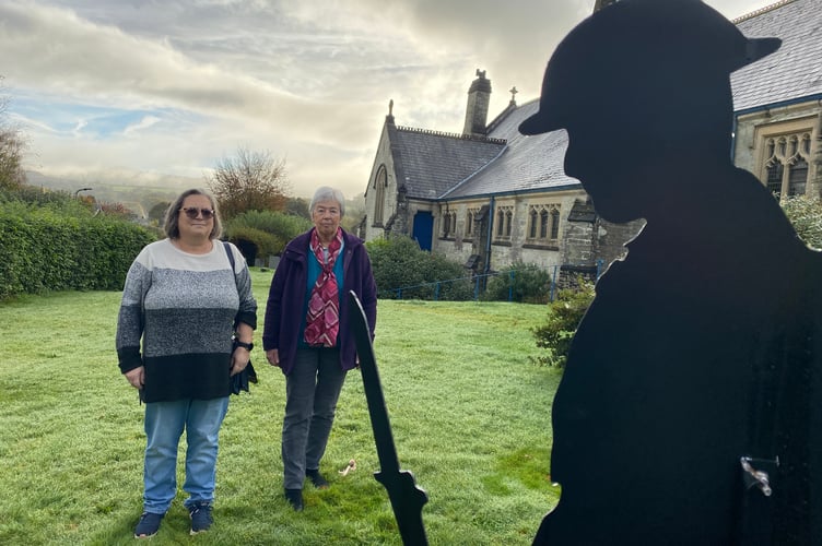 Colette Hutchins and Hilary Prout inspect the new Remembrance silhouette figures in Horrabridge Churchyard.J