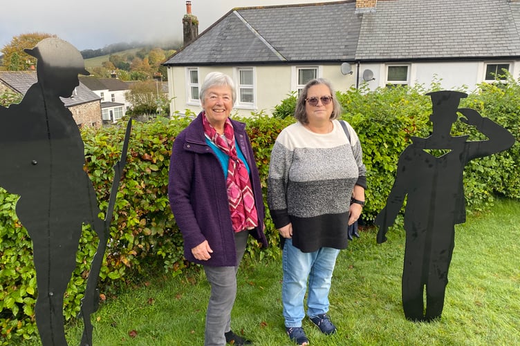 Colette Hutchins and Hilary Prout admiring the new military silhouette figures in Horrabridge Churchyard
