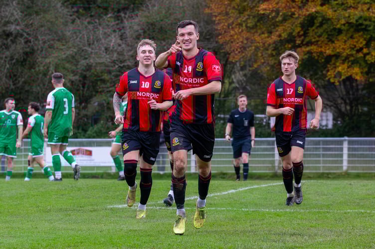 Ben Steer points to the camera after netting for Tavistock AFC