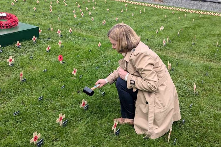 Rebecca Smith planting a poppy cross