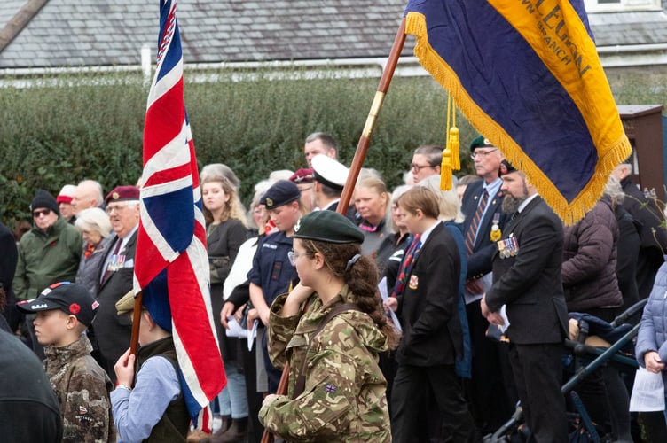 An Army cadet carries the Royal British Legion banner at Princetown's Remembrance parade and service.