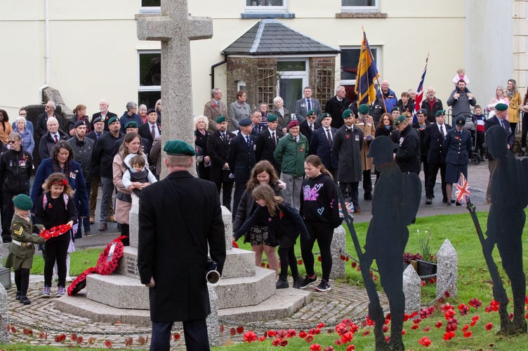 Children laying wreaths at Princetown War Memorial on Remembrance Sunday