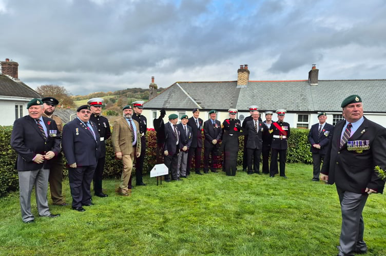 Veterans and serving military personnel gather for a period of reflection in Horrabridge churchyard after a parade and service on Remembrance Sunday. 