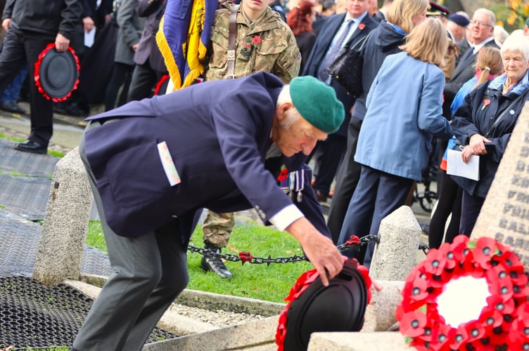 A Royal Marines veteran lays a wreath at the Tavistock War Memorial during the Remembrance Sunday