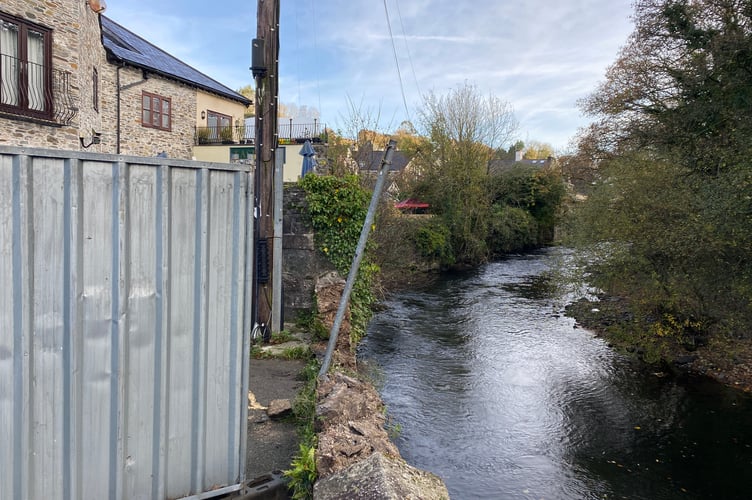 Market Road River Tavy wall damaged and fenced off after a road incident when one woman was hurt.