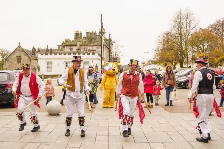 Pudsey bear watching the Morris dancers in Tavistock