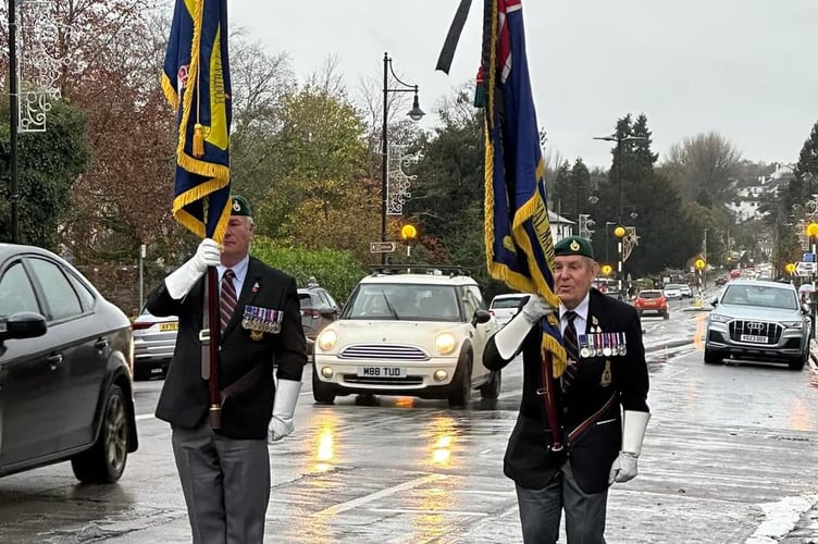 Military veterans pay tribute to Lt Col Peter Cameron flying military colours in Tavistock.
