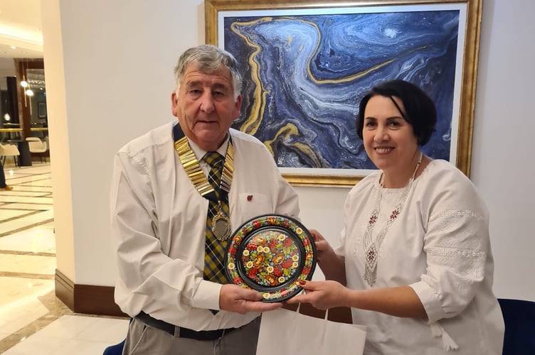 Calstock Parish Council chair Jim Wakem accepts a gift from the Ukrainian village of Petrykivka, newly twinned with Calstock