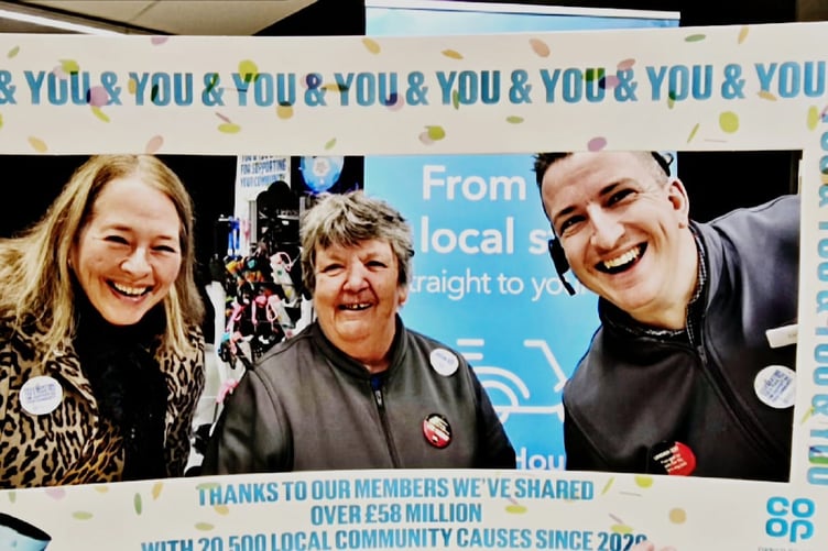 Coop staff members celebrate a donation from the company to Tavistock Dementia Alliance chair Lynn Roddy (left)..