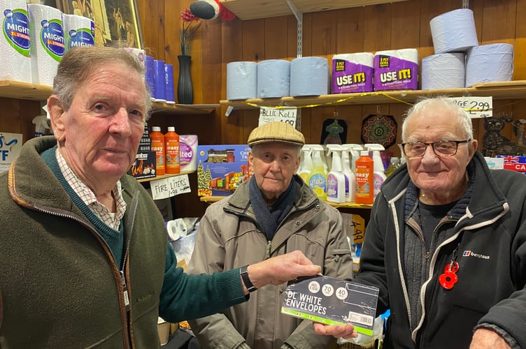 Andrew Joynson (pictured left), encourages shoppers to use independent traders after buying envelopes six times cheaper at Tavistock Pannier Market than in a chain shop.  Market trader Charlie Snell and helper Dave Harvey help Andrew make a saving. 