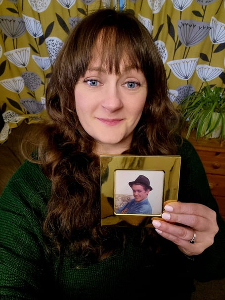 Kate Hooper holding a picture of her late brother, Michael