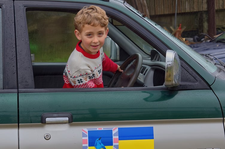 Generous Monty Batterick helps pack his donations for Ukrainian children.