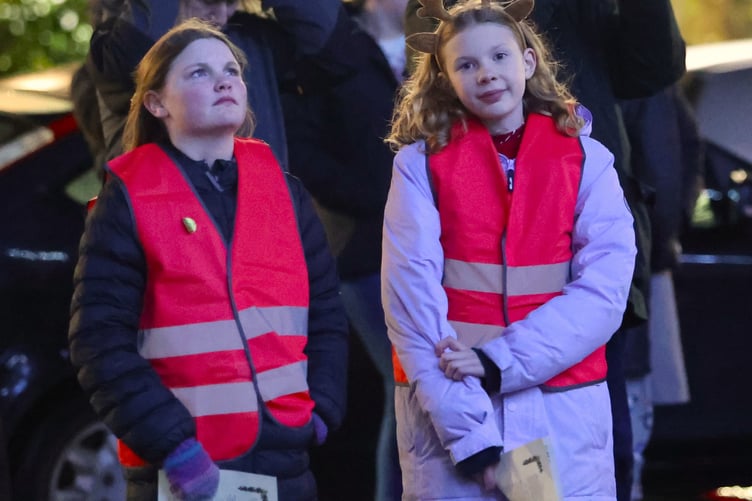 Getting into the Christmas spirit are two girls at Tavistock Lions' Trees of Light switch-on in Bedford Square.