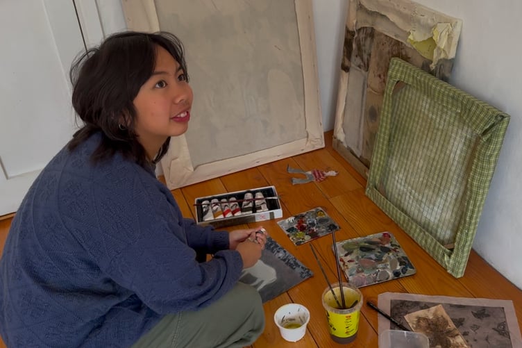 Bethenie Carriaga with their artwork