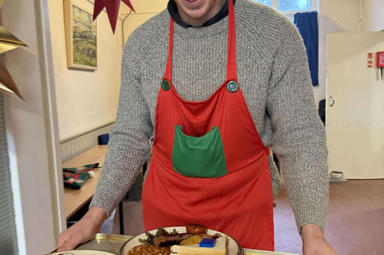 Young farmer Jordan Taylor delivers a tray of breakfasts