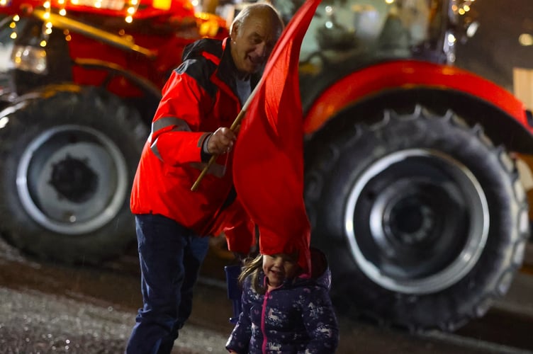 A little girl gets enjoys the festive atmosphere of Tavistock's Christmas tractor run. By Chris Cottrell.