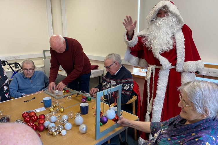 Santa visited the care and share group of Tavistock Memory Cafe as they crafted Christmas decorations in Tavistock Library.