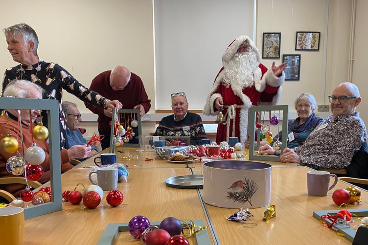 Santa paid a flying visit to Tavistock Memory Cafe at Tavistock Library as they made Christmas decorations.