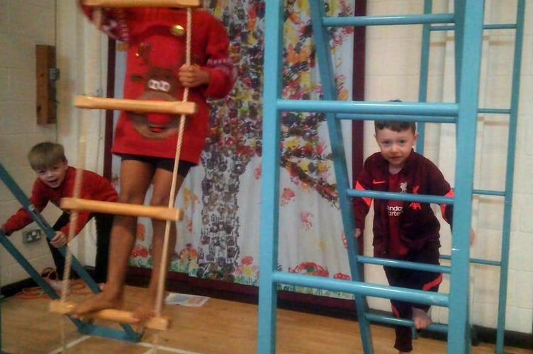 Horrabridge School children scaling ladders for their charity Santa Run.