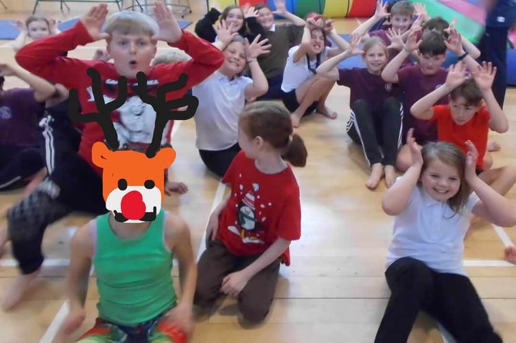 Horrabridge School pupils in festive jumpers taking part in their charity Santa Run obstacle course which raised money for St Luke's Hospice.
