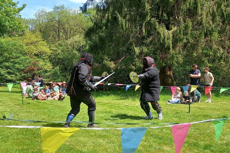 Members of Mystic Swords fighting outside Okehampton Castle