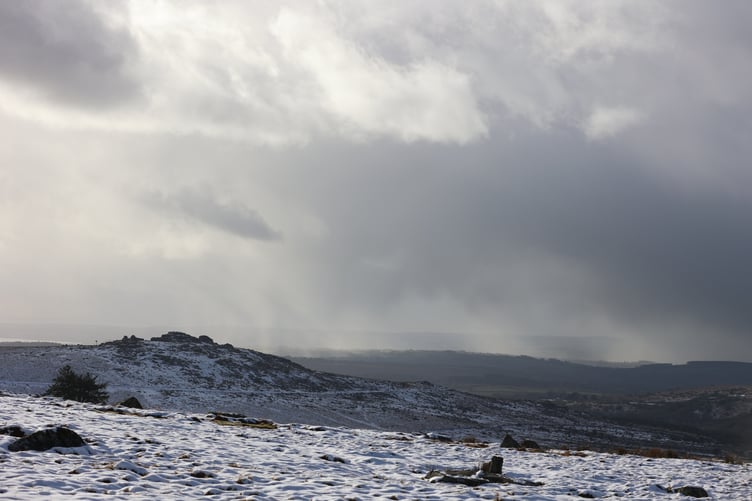Snow flurries in the sky above frozen snow on Dartmoor near Tavistock. By Chris Cottrell.