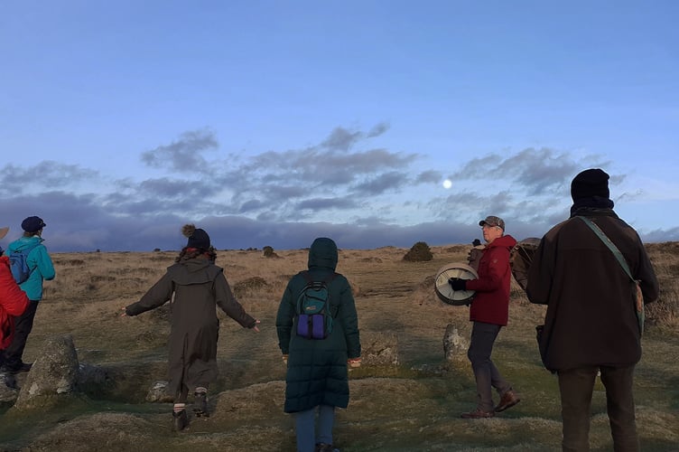 A perfect sunset over Yes Tor with the moon rising in a blue sky