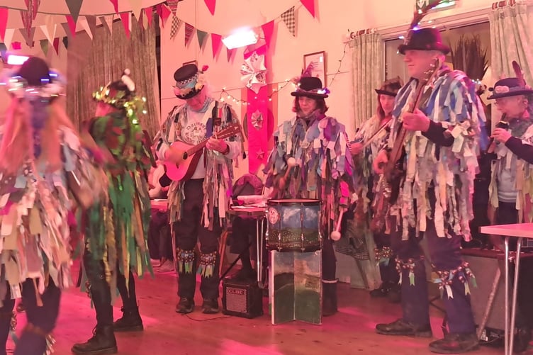 Morris dancing and singing celebrating wassailing at Bere Ferrers