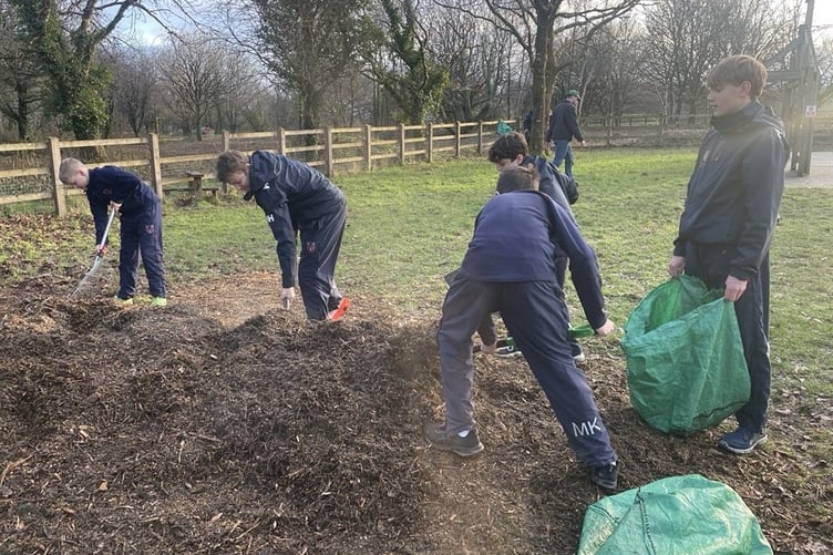 Mount Kelly College students laying a safe surface at Yelverton Play Park for their Duke of Edinburgh Award.