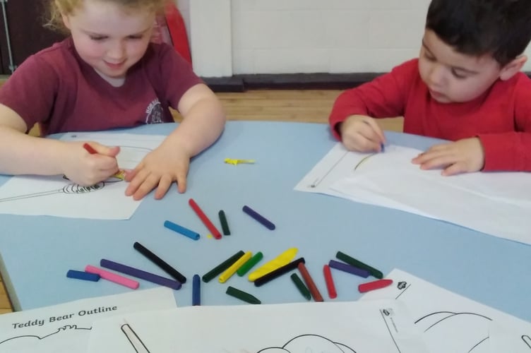 Having fun drawing honey pots to mark Winnie the Pooh Day at Horrabridge School.