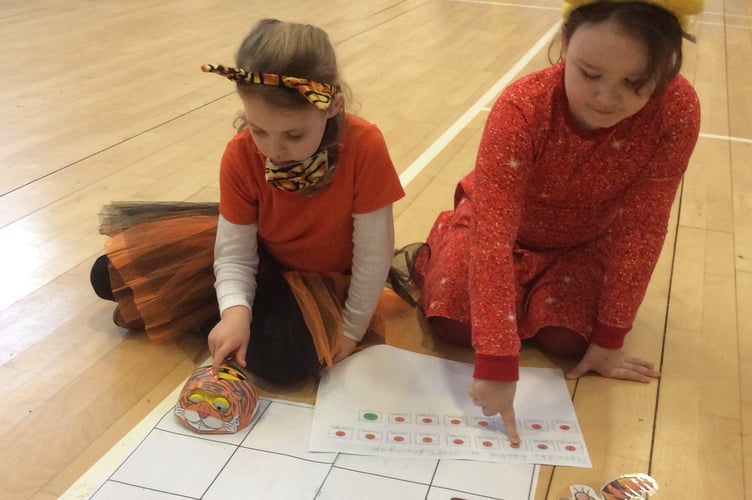Celebrating Winnie the Pooh Day at Horrabridge School with a Tigger-themed board game.