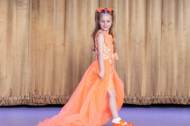 Scarlett Hearn, five, in her glamorous dress on her way to winning the UK finals of the Pure US pageant. 