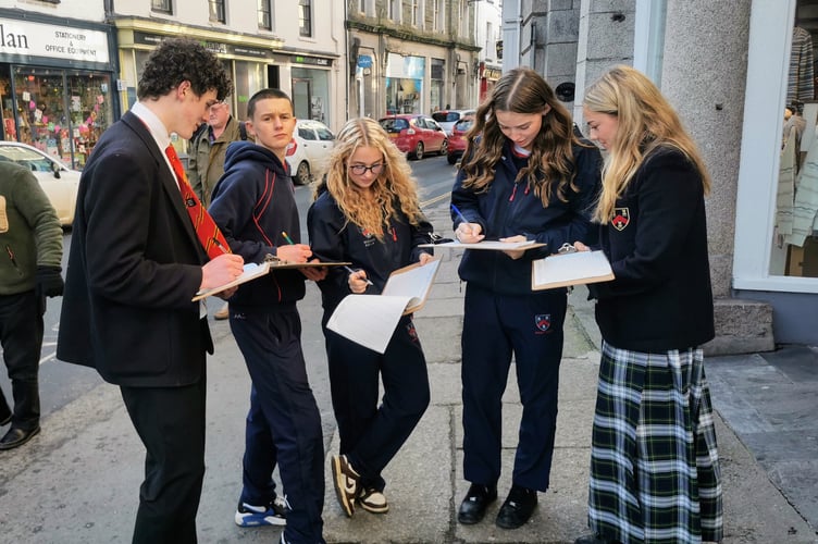 Mount Kelly College students conduct a retail survey in Tavistock high street