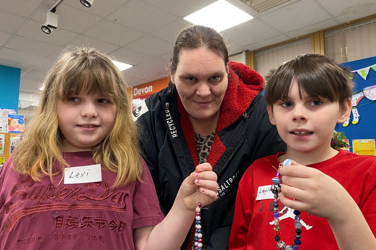 Carrie Hawke with children Lexi, 9, and Layland, 10, enjoy making bracelets at a half-term session