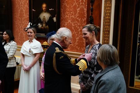 Paula Tobin receives a Humanitarian Medal from King Charles at Buckingham Palace