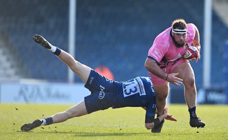 Exeter Chiefs prop Josh Iosefa-Scott powers his way past Sale Sharks centre Joe Bedlow during their Premiership Rugby Cup clash at Sandy Park