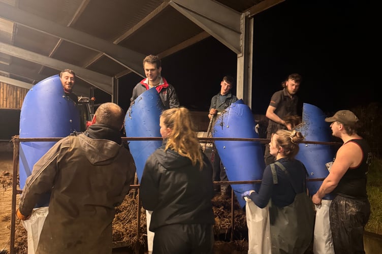 The dung bagging production line, manned by the young farmers