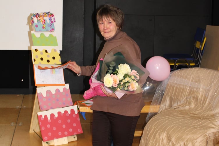 Janet Cope receives her flowers and an artistic farewell card 'sculpture' in the shape of a tiered cake.