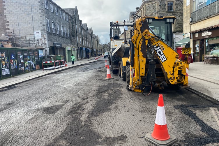 Digging up the high street which has been peppered by potholes and crumbling surface.