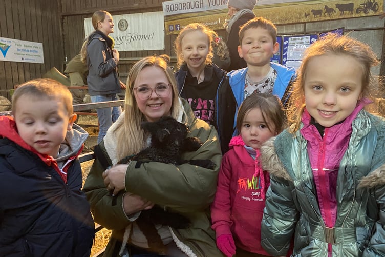 Mum Janique with her children Amore, 8, Rosalie, 5, and Elias, 3, with friends Joey, 3, and Rog, 8, enjoying getting close to new lambs at Greewell Farm, Yelverton.