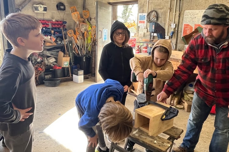 Checking the measurements for a wildlife home by Horrabridge School.