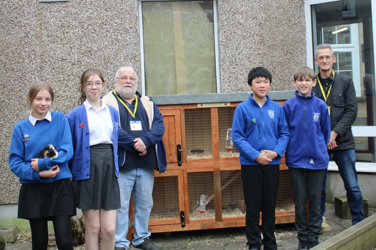 Tavistock Men in Sheds members present their guinea pig hutches to the children Tavistock Primary School, pictured with some of their guinea pigs.