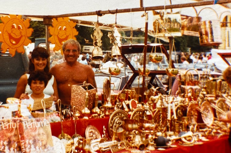 Charlie Snell selling his brass goods on his market stall at Liskeard Show several decades ago. The Tavistock Pannier Market trader is with Jackie Taylor and her son Colin (now a retired policeman).