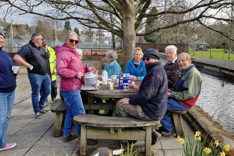 The work party having a break from a makeover at Tavistock Sensory Garden. 